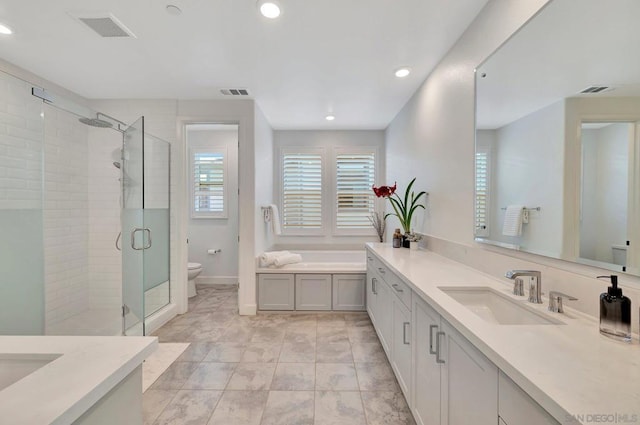 bathroom featuring toilet, tile patterned flooring, a shower with shower door, and vanity