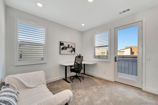 office area featuring light carpet