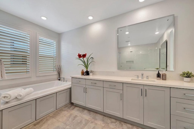 bathroom featuring shower with separate bathtub and vanity