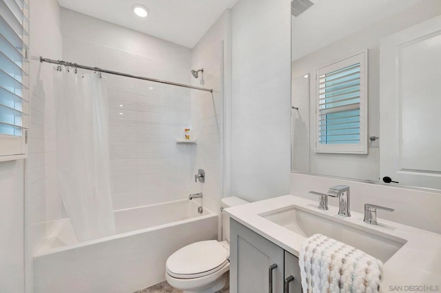 full bathroom featuring shower / bathtub combination with curtain, vanity, and toilet