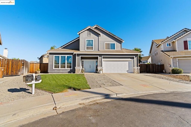 view of front of property with a front yard and a garage