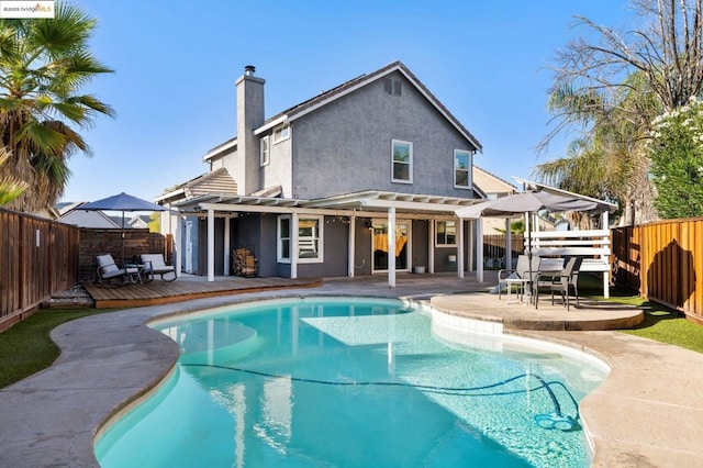 view of pool featuring a pergola, a patio area, and a deck