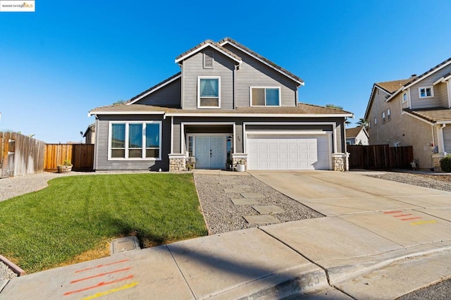 view of front of house featuring a front yard and a garage