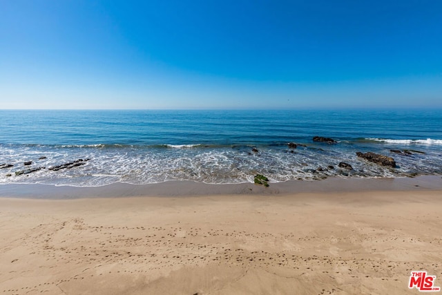 property view of water featuring a beach view