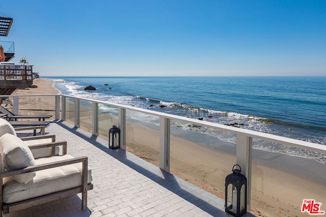 balcony with a view of the beach and a water view