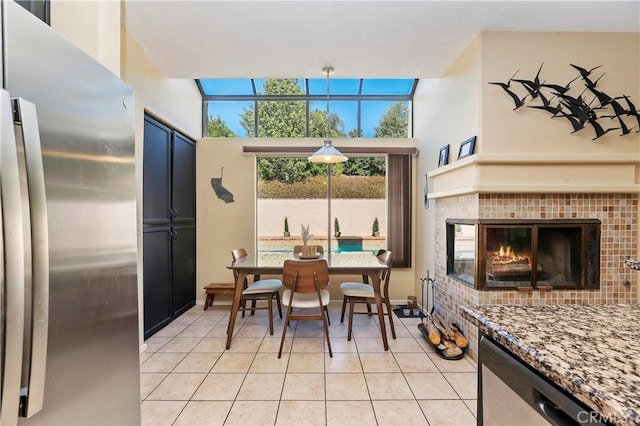 tiled dining area with a tile fireplace