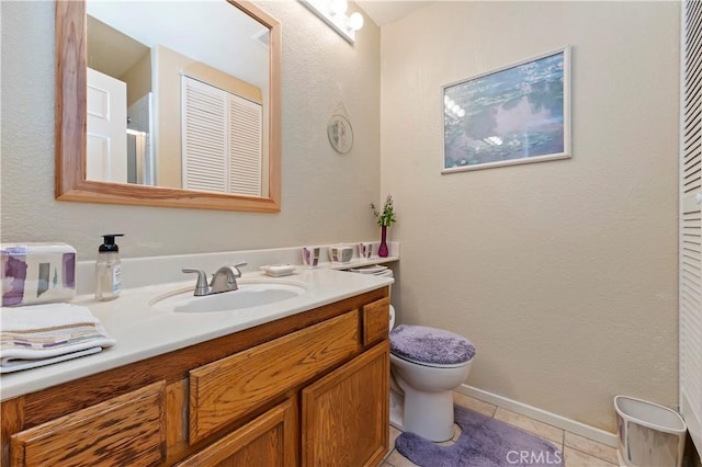 bathroom with tile patterned flooring, vanity, and toilet