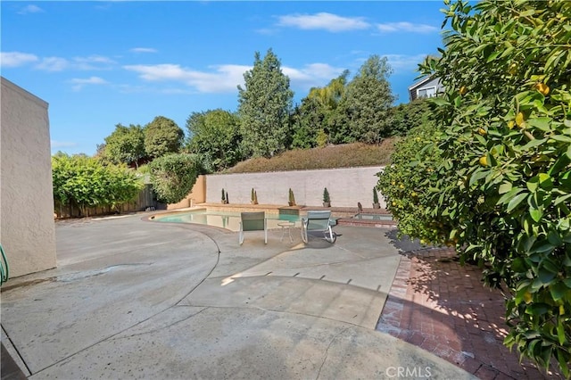 view of patio with a fenced in pool and fence
