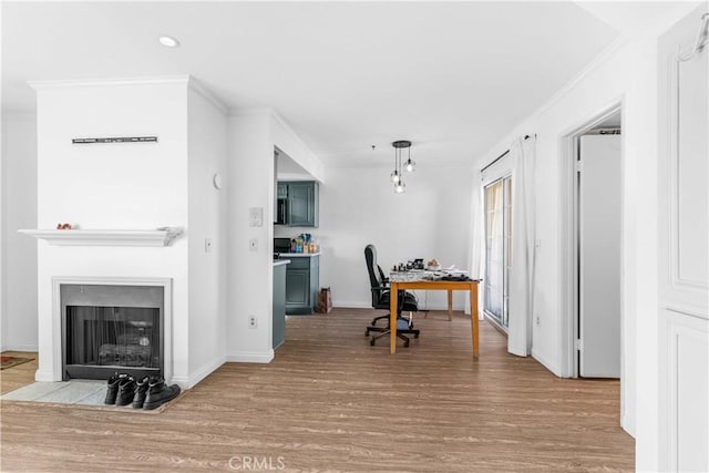 office featuring crown molding and light hardwood / wood-style floors