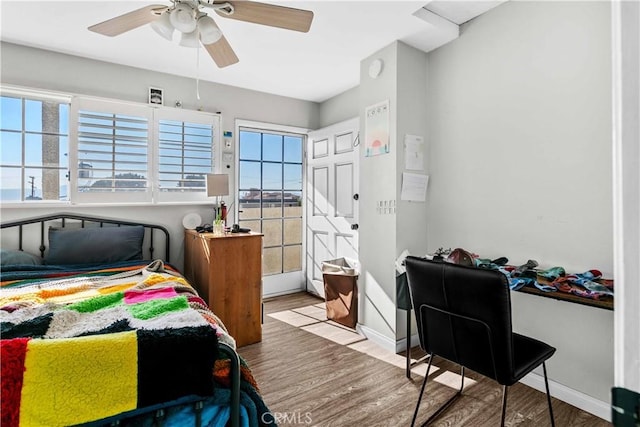 bedroom with ceiling fan and light hardwood / wood-style floors