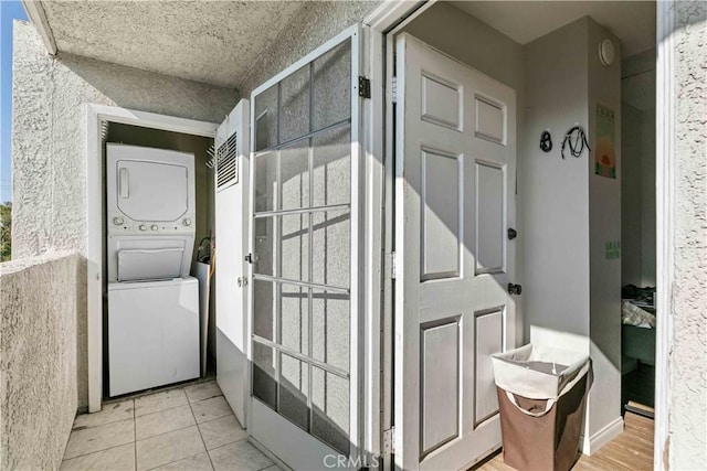 exterior space with stacked washer and dryer