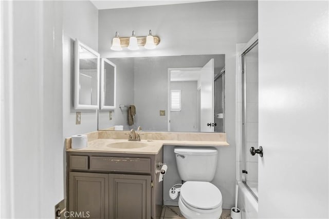 full bathroom featuring shower / bath combination with glass door, vanity, and toilet