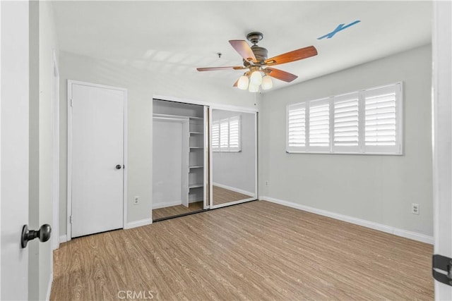 unfurnished bedroom with ceiling fan, a closet, and light hardwood / wood-style flooring