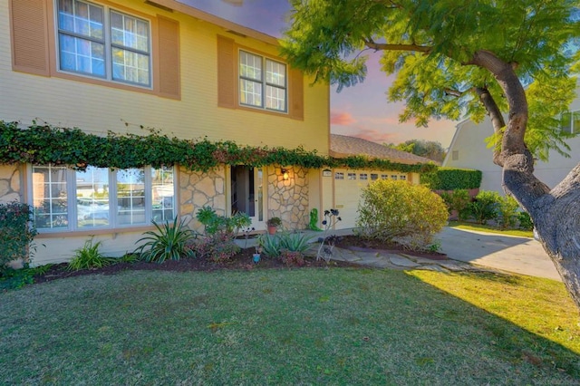 view of front of home with a lawn and a garage