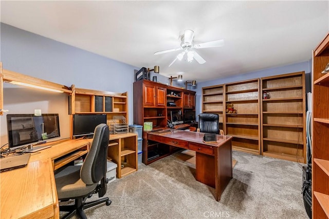 home office featuring light carpet and ceiling fan