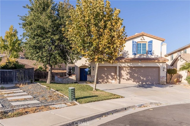 view of front of property featuring a garage and a front lawn