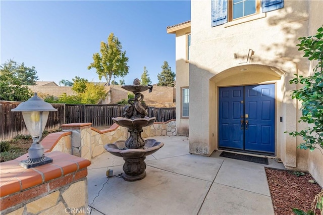 property entrance featuring a patio