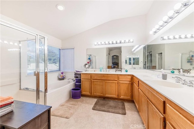 bathroom with tile patterned flooring, vanity, vaulted ceiling, and independent shower and bath