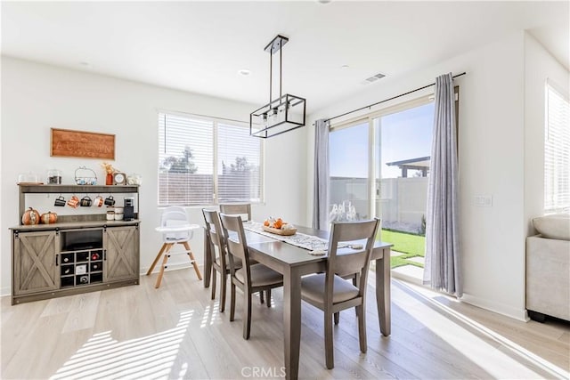 dining space with light wood-type flooring