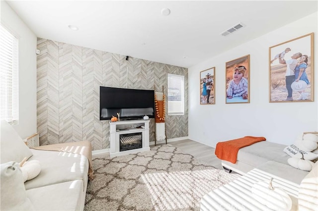 living room featuring a tiled fireplace