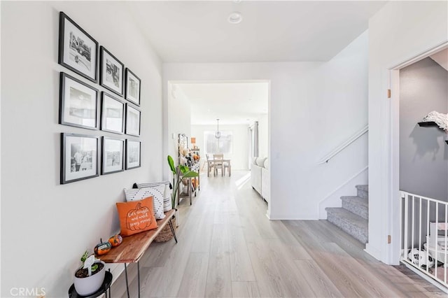 hallway with light hardwood / wood-style flooring