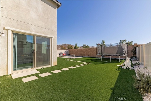 view of yard with a patio area and a trampoline