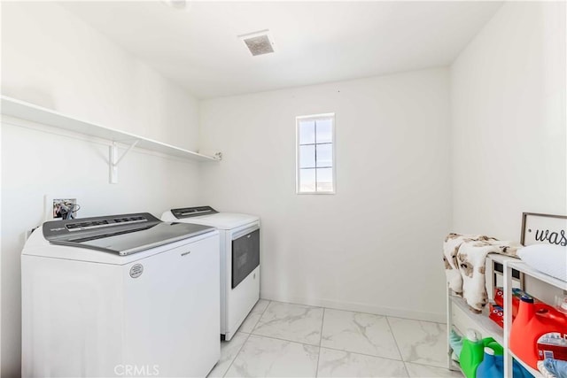 clothes washing area with washing machine and dryer