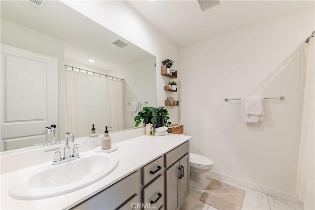 bathroom featuring vanity and toilet