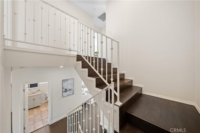 stairway featuring hardwood / wood-style floors