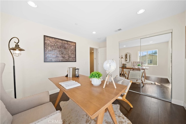 dining space with hardwood / wood-style flooring