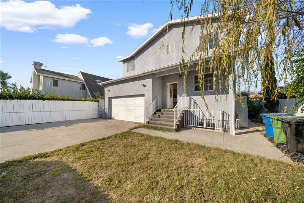 back of property featuring a yard and a garage