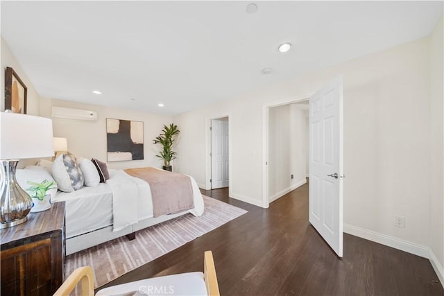 bedroom featuring an AC wall unit and dark wood-type flooring