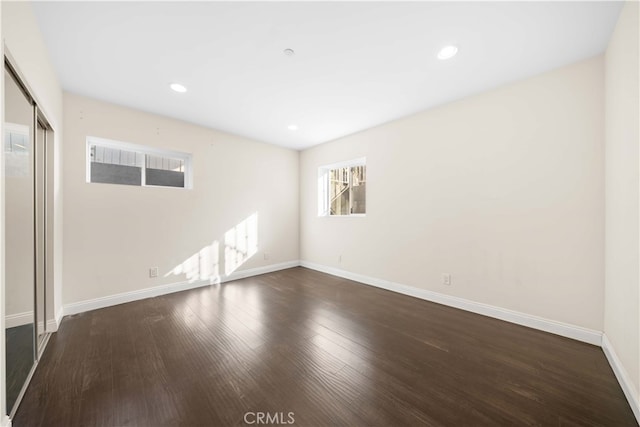 empty room with dark hardwood / wood-style floors