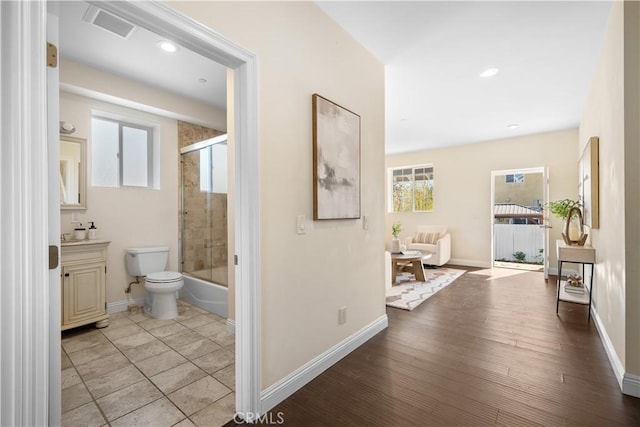 hall with light hardwood / wood-style floors