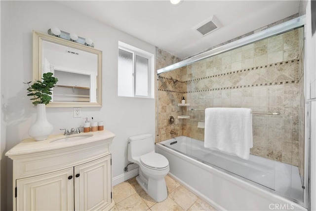 full bathroom with shower / bath combination with glass door, vanity, toilet, and tile patterned flooring