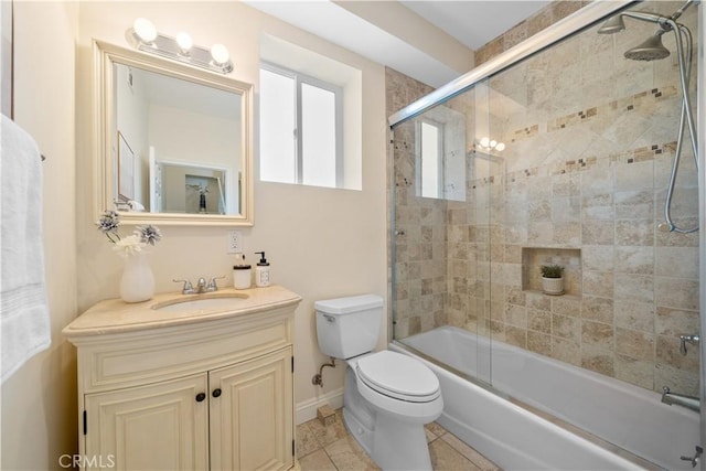 full bathroom with tile patterned floors, vanity, toilet, and combined bath / shower with glass door