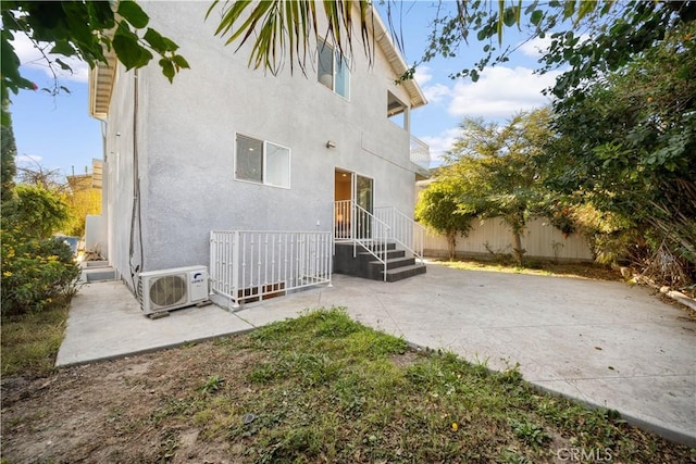 back of property featuring ac unit and a patio area