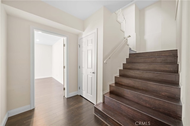 stairs featuring wood-type flooring