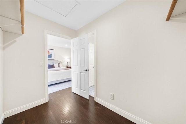 hallway with dark hardwood / wood-style floors