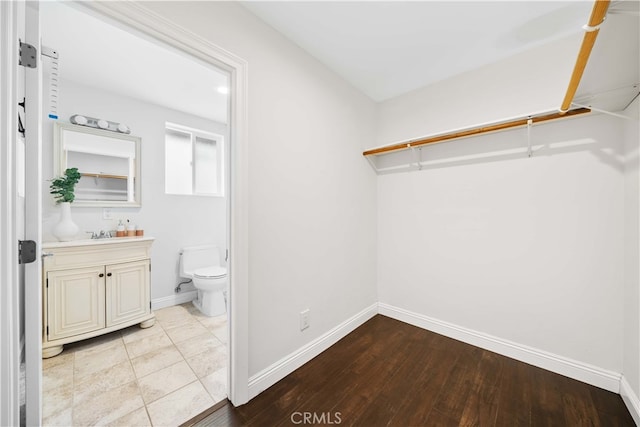 spacious closet featuring light wood-type flooring