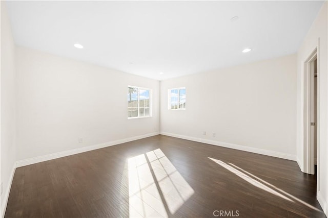 spare room featuring dark hardwood / wood-style flooring