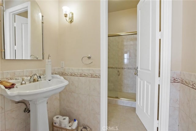 bathroom featuring tile patterned floors, tile walls, and walk in shower