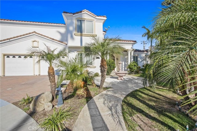 mediterranean / spanish house with a garage