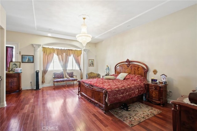 bedroom featuring a tray ceiling and dark hardwood / wood-style flooring