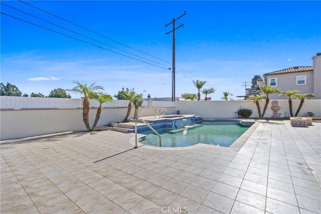 view of pool featuring an in ground hot tub and a patio