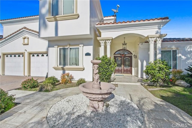 view of front of house with french doors and a garage