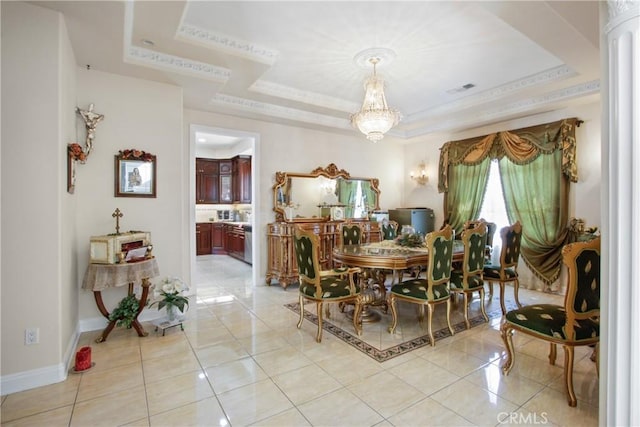 dining area featuring a raised ceiling, light tile patterned floors, and an inviting chandelier