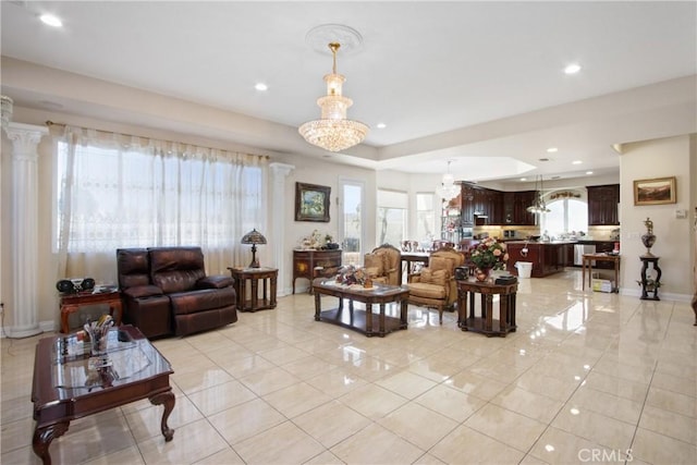 tiled living room featuring a notable chandelier