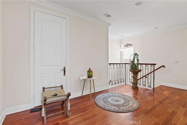 interior space featuring hardwood / wood-style flooring and ornamental molding