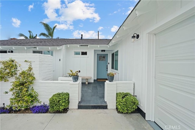 doorway to property with a garage